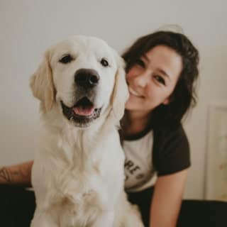 Girl sitting with her happy pet