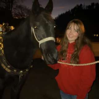 Girl with smiling black horse